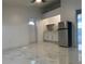 Open living space with marble-look floors and a ceiling fan at 8601 Twin Lakes Blvd, Tampa, FL 33614