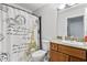 Bathroom with granite vanity, shower/tub combo, and decorative shower curtain at 10265 Gandy N Blvd # 905, St Petersburg, FL 33702