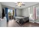 Bedroom with gray bedding, a large window, and wood-look floors at 10265 Gandy N Blvd # 905, St Petersburg, FL 33702