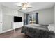 Bedroom with gray bedding, window, and a large dresser at 10265 Gandy N Blvd # 905, St Petersburg, FL 33702