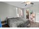 Bedroom with gray bedding, window, and a walk-in closet at 10265 Gandy N Blvd # 905, St Petersburg, FL 33702