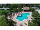 Inviting community pool and hot tub with tables, chairs and shade at 10265 Gandy N Blvd # 905, St Petersburg, FL 33702
