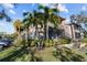 Exterior view of condo building with lush landscaping and palm trees at 10265 Gandy N Blvd # 905, St Petersburg, FL 33702