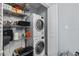 Stackable washer and dryer in a well-organized laundry room with shelving at 10265 Gandy N Blvd # 905, St Petersburg, FL 33702