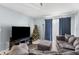 Living room with a Christmas tree, sectional sofa, and large TV at 10265 Gandy N Blvd # 905, St Petersburg, FL 33702