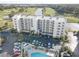 Aerial view of condo building, pool, and surrounding golf course at 1200 Country Club Dr # 2504, Largo, FL 33771