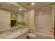 Clean bathroom with a bathtub, shower, and granite vanity at 1200 Country Club Dr # 2504, Largo, FL 33771