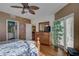 Bedroom with wood floors, a floral comforter, and access to a bathroom at 1200 Country Club Dr # 2504, Largo, FL 33771