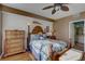 Bedroom with wood floors, a floral comforter, and dresser at 1200 Country Club Dr # 2504, Largo, FL 33771