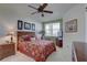 Bright bedroom with a comfortable bed, ceiling fan, and wood furniture at 1200 Country Club Dr # 2504, Largo, FL 33771