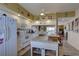 Kitchen with white cabinets, granite counters, and island at 1200 Country Club Dr # 2504, Largo, FL 33771
