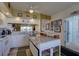 Kitchen with white cabinets, granite counters, and island at 1200 Country Club Dr # 2504, Largo, FL 33771