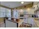 Kitchen with white cabinets, granite counters, and island at 1200 Country Club Dr # 2504, Largo, FL 33771
