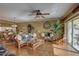 Living room with wicker furniture and sliding glass doors at 1200 Country Club Dr # 2504, Largo, FL 33771