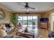 Spacious living room with hardwood floors, golf course view, and wicker furniture at 1200 Country Club Dr # 2504, Largo, FL 33771