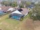 This aerial shot showcases the home's location, lush landscaping, and the inviting screened-in pool at 1515 Lions Club Dr, Brandon, FL 33511