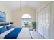 Cozy bedroom showcasing tile floors, an arched window, a closet, and a comfy bed at 1515 Lions Club Dr, Brandon, FL 33511