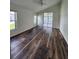 Comfortable bedroom featuring hardwood flooring and access to a screened lanai at 1515 Lions Club Dr, Brandon, FL 33511
