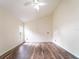 Open bedroom with hardwood floors, fan, and window with natural light at 1515 Lions Club Dr, Brandon, FL 33511
