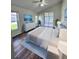 Well-appointed bedroom with wood floors, bright natural light, and ensuite bathroom at 1515 Lions Club Dr, Brandon, FL 33511