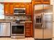 Close-up showcasing stainless steel appliances, granite countertops, and beautiful wood cabinets at 1515 Lions Club Dr, Brandon, FL 33511