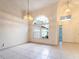 Bright living room with large windows, tiled floor, and elegant lighting fixtures at 1515 Lions Club Dr, Brandon, FL 33511