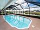 Relax in the beautiful screened-in pool, overlooking a serene lake, a perfect outdoor retreat at 1515 Lions Club Dr, Brandon, FL 33511