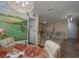 Bright dining area with charming mural and adjacent kitchen access at 1600 Idle Dr, Clearwater, FL 33756