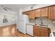Kitchen with wood cabinets, granite counters and white appliances at 2262 Swedish Dr # 12, Clearwater, FL 33763