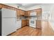 Kitchen boasts wood cabinets, granite counters, and white appliances at 2262 Swedish Dr # 12, Clearwater, FL 33763