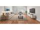 Living room with hardwood floors, sofa, and large TV at 2262 Swedish Dr # 12, Clearwater, FL 33763