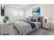 Main bedroom with plush bedding, large art piece, and nightstands at 2262 Swedish Dr # 12, Clearwater, FL 33763