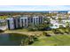 An aerial view of a condo building, golf course, and waterfront at 2320 Terra Ceia Bay Blvd # 403, Palmetto, FL 34221