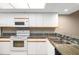 Kitchen with white cabinets, granite counters, and appliances at 2320 Terra Ceia Bay Blvd # 403, Palmetto, FL 34221