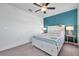 Spacious bedroom with a ceiling fan and a teal accent wall at 31371 Cabana Rye Ave, San Antonio, FL 33576