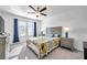 Bright bedroom with a queen bed, two nightstands, and large windows at 31371 Cabana Rye Ave, San Antonio, FL 33576
