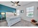 Comfortable bedroom featuring a large bed, ceiling fan and plenty of natural light at 31371 Cabana Rye Ave, San Antonio, FL 33576