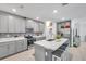 Modern kitchen with gray cabinets, island, and stainless steel appliances at 31371 Cabana Rye Ave, San Antonio, FL 33576