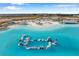 Aerial view of a lagoon amenity with beach and floating playground at 31371 Cabana Rye Ave, San Antonio, FL 33576