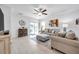 Living room with a comfortable sofa, ottoman, and sliding glass doors at 31371 Cabana Rye Ave, San Antonio, FL 33576