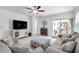 Bright living room features comfortable seating and a large TV at 31371 Cabana Rye Ave, San Antonio, FL 33576
