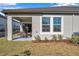 Covered patio with wicker furniture, adjacent to the house at 31371 Cabana Rye Ave, San Antonio, FL 33576