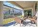 Relaxing covered patio with wicker furniture and view of backyard at 31371 Cabana Rye Ave, San Antonio, FL 33576