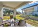 Covered patio overlooks backyard with grassy area and trees at 31371 Cabana Rye Ave, San Antonio, FL 33576
