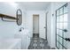 Bathroom featuring a black framed shower, modern vanity, and designer tile flooring at 5627 War Admiral Dr, Wesley Chapel, FL 33544