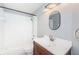 Cozy bathroom with a shower and tub combination, a wooden vanity, and sleek chrome fixtures at 5627 War Admiral Dr, Wesley Chapel, FL 33544