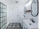 Modern bathroom with double vanity, black fixtures, stylish tile floors, and glass shower at 5627 War Admiral Dr, Wesley Chapel, FL 33544
