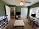 Bedroom with a ceiling fan, natural light, and a closet space that is set up as an office at 5627 War Admiral Dr, Wesley Chapel, FL 33544