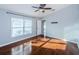 Spacious bedroom with lots of natural light, wood flooring and open doorway to another room at 5627 War Admiral Dr, Wesley Chapel, FL 33544