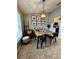 Bright dining area featuring modern chandelier, stylish seating, and decor at 5627 War Admiral Dr, Wesley Chapel, FL 33544